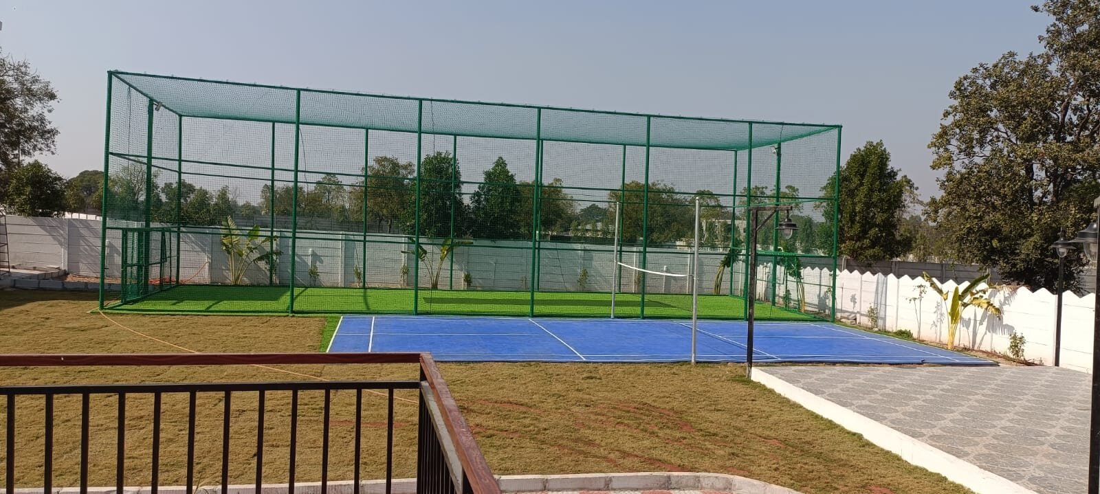 The box cricket net and the badminton and pickleball court