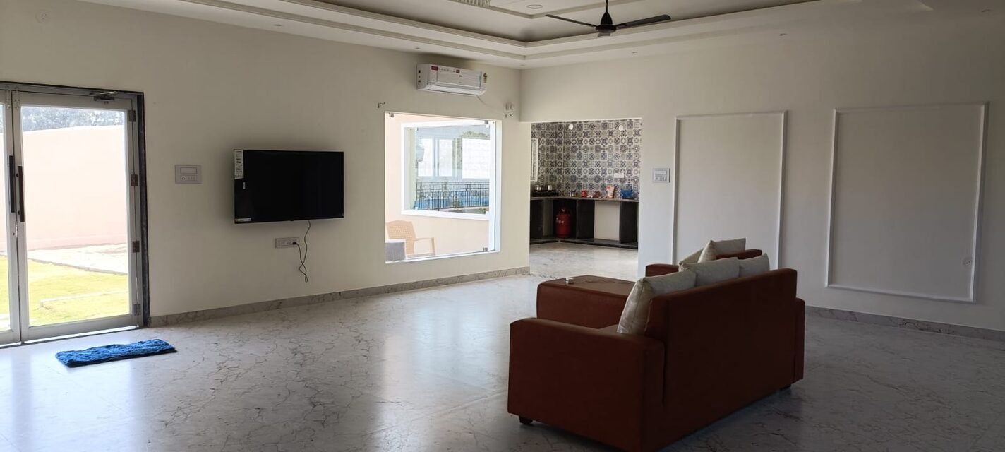 The living room, with the kitchen beyond